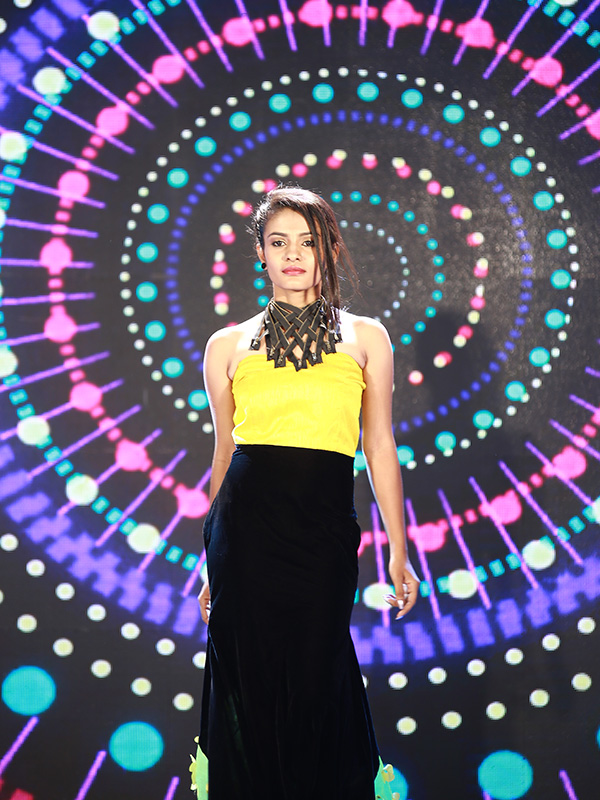 Striking fashion photography with Bee Bee Videos in Coimbatore, showcasing a model in modern attire with a colorful light display background.