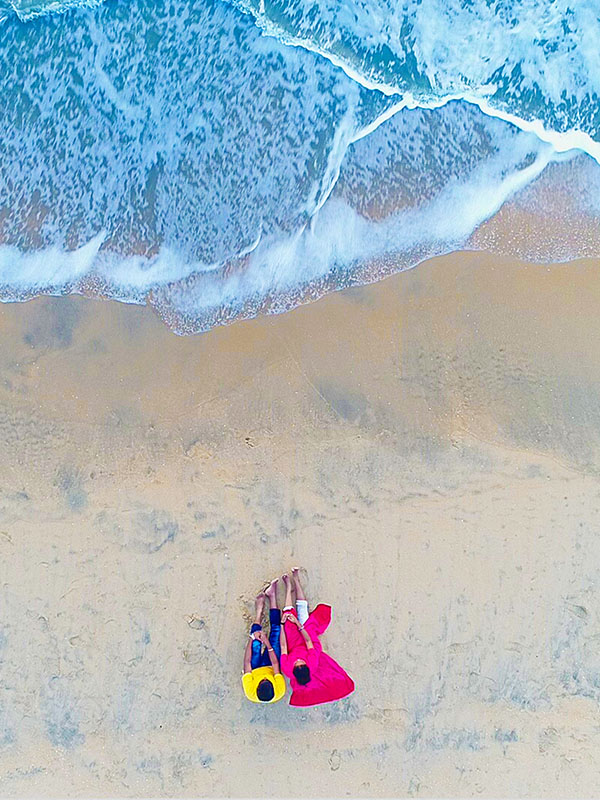 Top-down view of a serene beach moment captured by Bee Bee Videos' drone photoshoot.