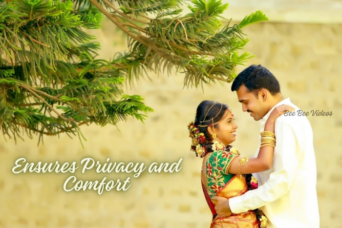 Tender and private embrace between bride and groom amidst serene greenery, artfully photographed by Bee Bee Videos, Coimbatore's wedding photography experts