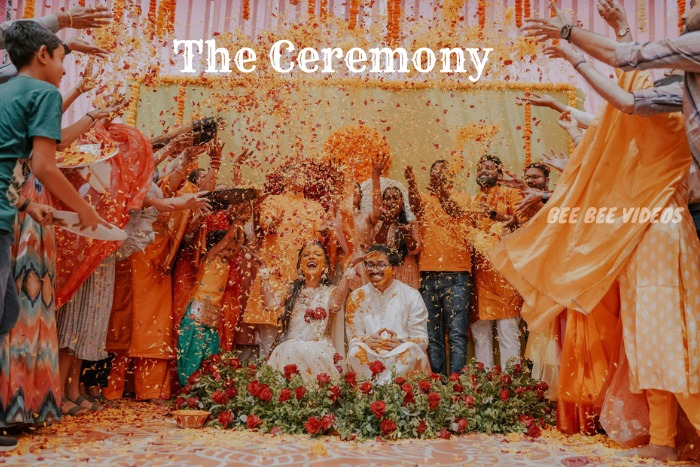 Joyful wedding ceremony in Coimbatore captured by Bee Bee Videos, featuring a bride and groom showered with flower petals by family and friends, highlighting the vibrant and festive atmosphere