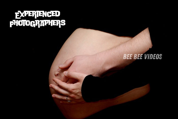 Close-up of a pregnant belly with hands gently cradling it, captured by Bee Bee Videos & Photography in Coimbatore, showcasing the expertise of their experienced photographers in maternity photography