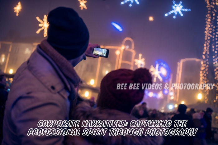 Two professionals in warm winter attire capture a vibrant corporate event at night using a smartphone, showcasing the magic of night-time corporate photography in Coimbatore. Bee Bee Videos & Photography specializes in capturing the essence of professional events with a unique, authentic touch