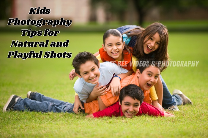 Happy kids captured in a playful moment stacked over each other on a green lawn by Bee Bee Videos & Photography in Coimbatore