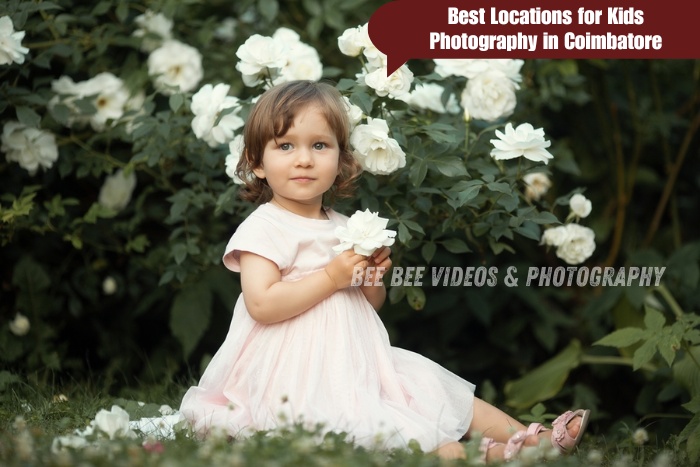 Adorable little girl sitting among white flowers in a beautiful garden setting in Coimbatore